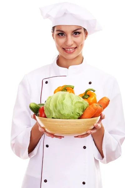 Portrait of young woman chef with vegetables isolated on white Royalty Free Stock Photos