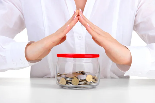 Woman hands with coins in glass jar, close up — Stock Photo, Image