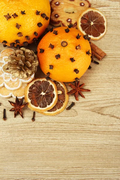 Composition of christmas spices and tangarines, on wooden background — Stock Photo, Image