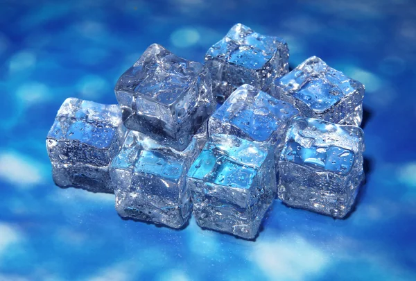 Ice cubes on color background — Stock Photo, Image