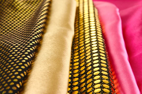 Hromadu různých textilií close-up pozadí — Stock fotografie