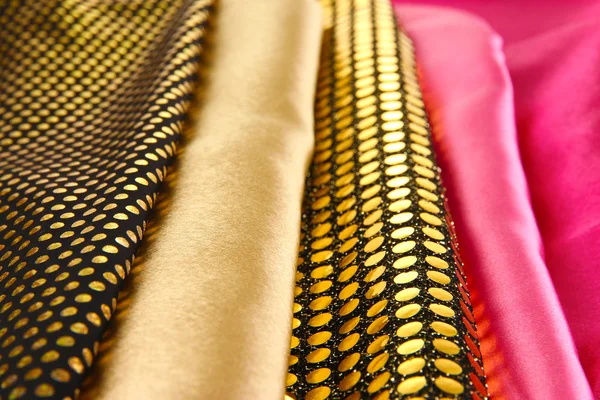 Pile of different fabrics close-up background — Stock Photo, Image