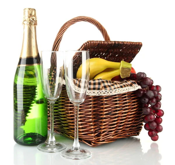 Picnic basket with fruits and bottle of champagne isolated on white — Stock Photo, Image