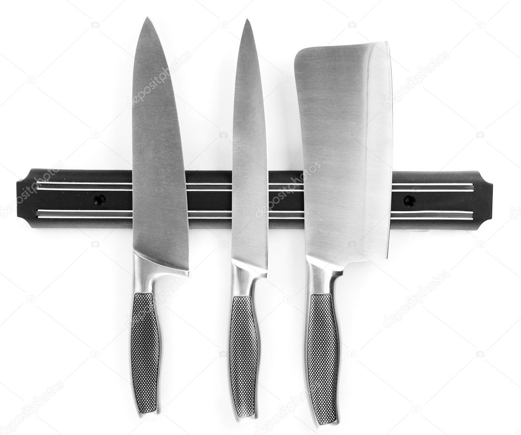 Set of knives on magnetic holder isolated on white