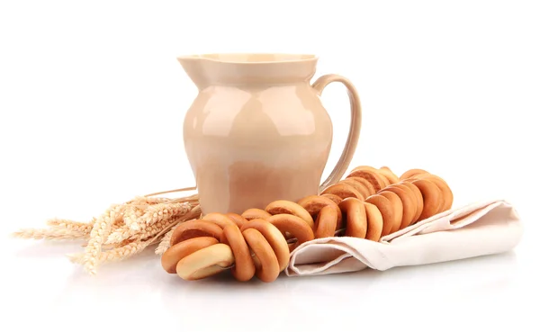 Jar of milk, tasty bagels and spikelets, isolated on white — Stock Photo, Image