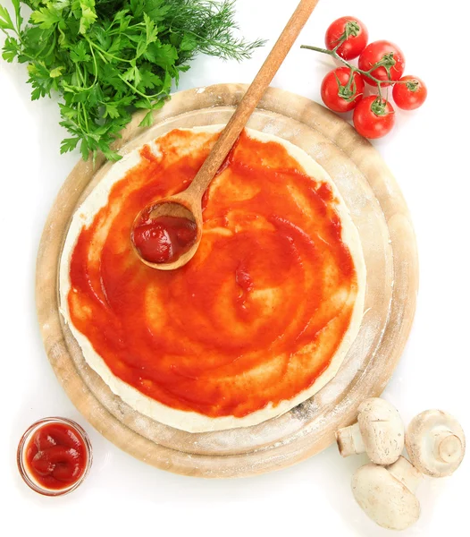 Pizza dough with tomato sauce on wooden board isolated on white — Stock Photo, Image