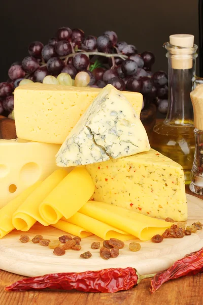 Various types of cheese on wooden board — Stock Photo, Image