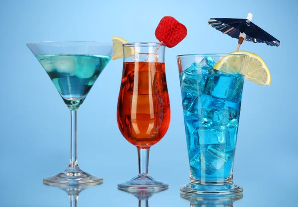 Alcoholic cocktails with ice on blue background — Stock Photo, Image