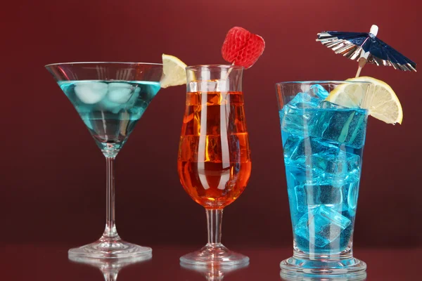 Alcoholic cocktails with ice on darck red background — Stock Photo, Image