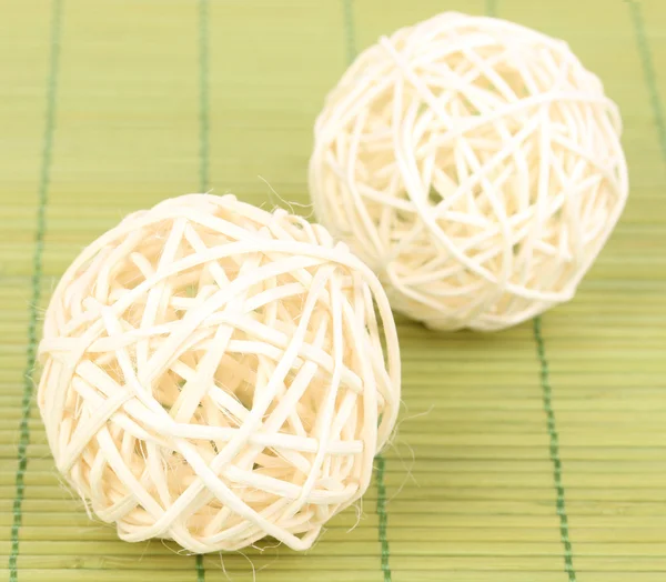 Wicker bamboo balls on bamboo mat — Stock Photo, Image