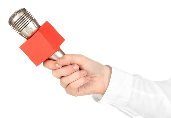 Mano femminile con microfono isolato su bianco — Foto Stock