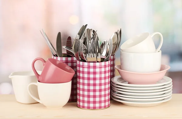 Cups, bowls nd other utensils in metal containers isolated on light background — Stok fotoğraf