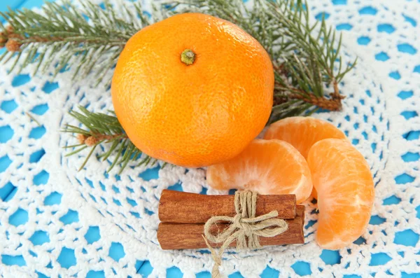 Tasty mandarines on napkin on blue background — Stock Photo, Image