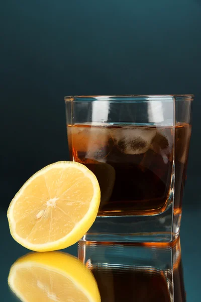 Bardak viski buz ve limon mavi zemin üzerine — Stok fotoğraf