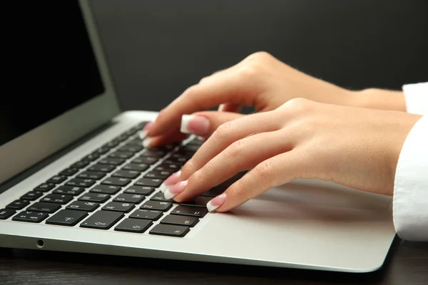 Female hands writing on laptot, close up Stock Photo