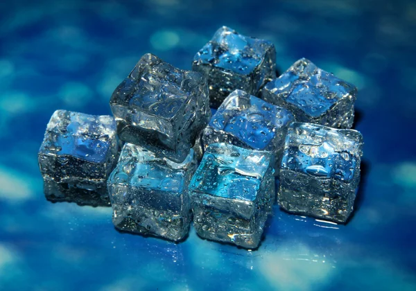 Ice cubes on color background — Stock Photo, Image