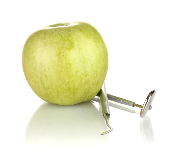 Green apple and dental tools isolated on white — Stock Photo, Image