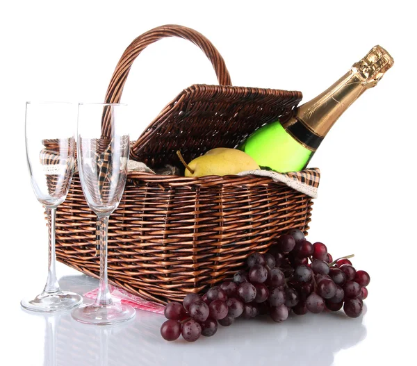 Picnic basket with fruits and bottle of champagne isolated on white — Stock Photo, Image