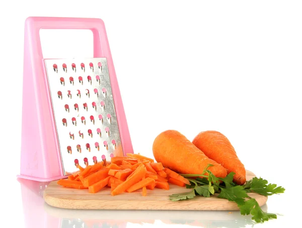 Carrots with grater on cutting board isolated on white — Stock Photo, Image