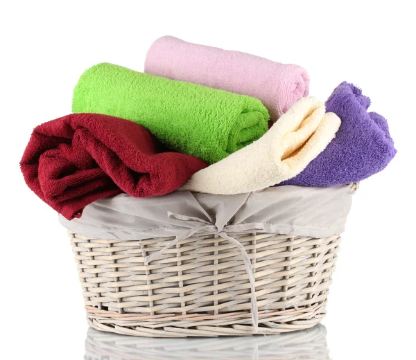 Colorful towels in basket isolated on white — Stock Photo, Image