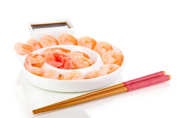 Prawns on plate with chopsticks and sauce isolated on white — Stock Photo, Image