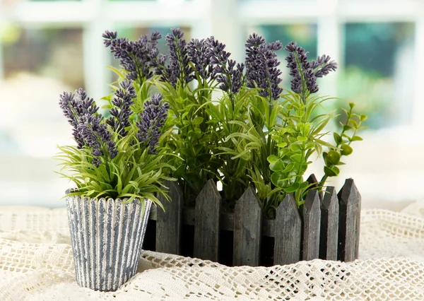 Decorative lavender in wooden box on wooden table on window background — Stock Photo, Image