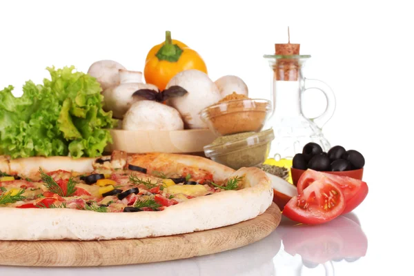 Delicious pizza on wooden board, vegetables, spices and oil isolated on white — Stock Photo, Image