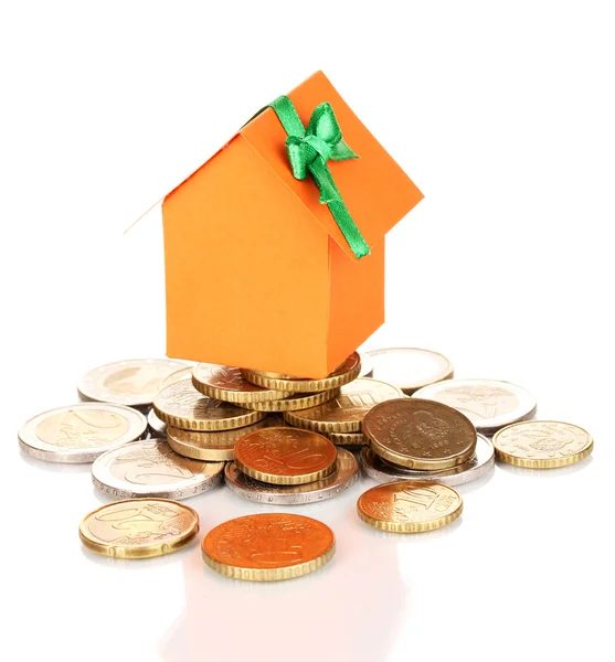 Small house standing on heap of coins — Stock Photo, Image