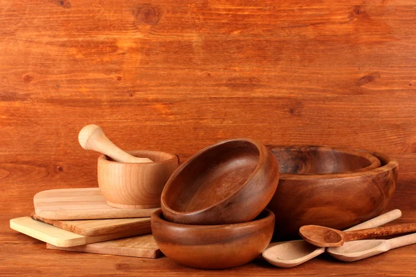 Wooden kitchen utensils on wooden background — Stock Photo, Image