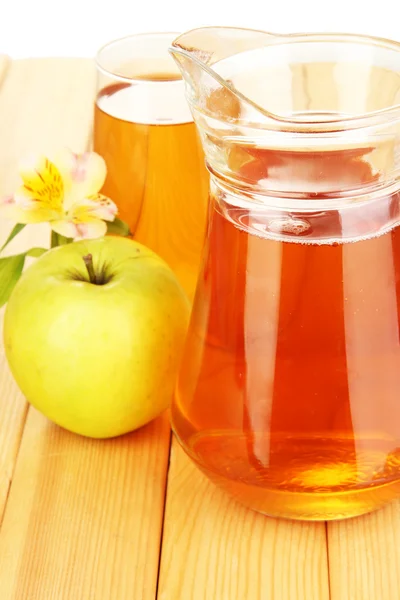 Fullt glas och kanna av äppeljuice och äpplen på träbord — Stockfoto