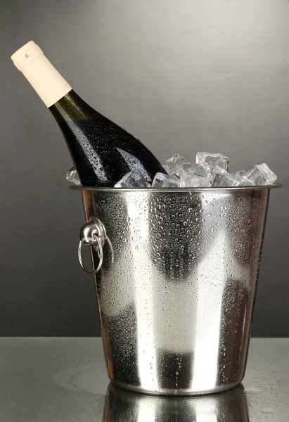 Bottle of wine in ice bucket on black background — Stock Photo, Image