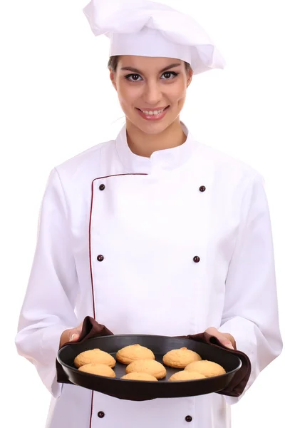 Portrait of young woman chef with cakes on dripping pan isolated on white Royalty Free Stock Photos
