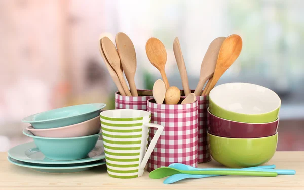 Cups, bowls nd other utensils in metal containers isolated on light background — Stock Photo, Image
