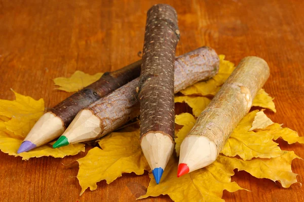 Színes fából készült ceruza, az őszi levelek, a fából készült asztal — Stock Fotó