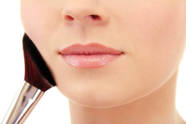 Portrait of beautiful woman with make-up brush for powder, isolated on white — Stock Photo, Image