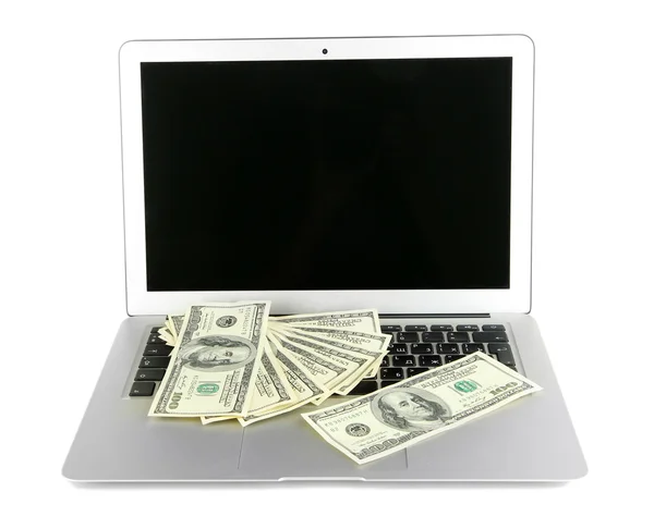 Geld op laptop geïsoleerd op wit — Stockfoto