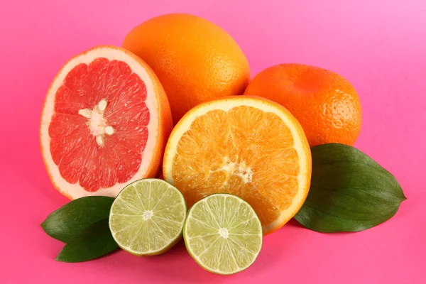 Fruits with leafs on pink background — Stock Photo, Image