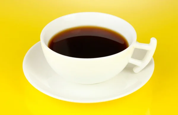 A cup of strong coffee on yellow background — Stock Photo, Image