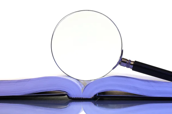 Magnifying glass and open book isolated on white — Stock Photo, Image
