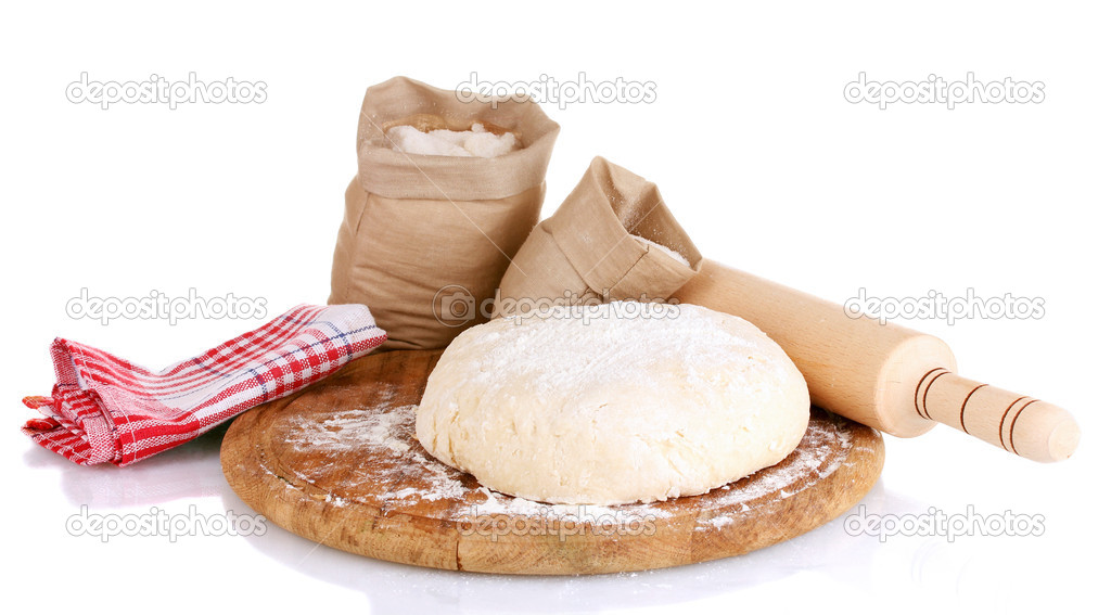 Dough and bags with flour on wooden board isolated on white