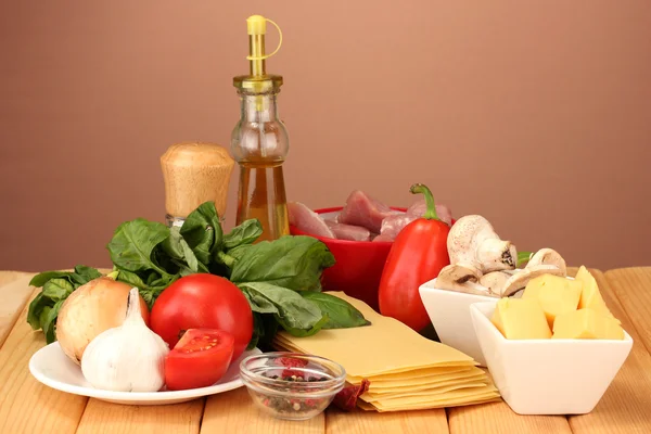 Lasagna ingredients on brown background — Stock Photo, Image