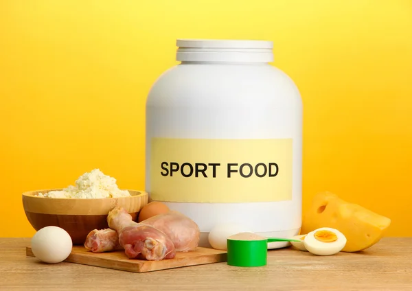 jar of protein powder and food with protein, on yellow background