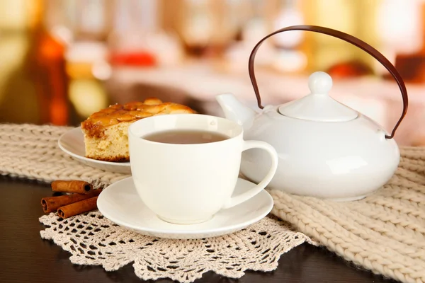 Cup of tea with scarf on table in room — Stock Photo, Image