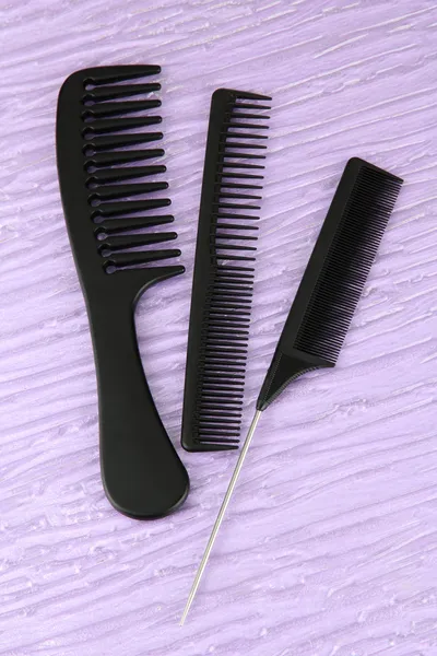 Black combs on color background — Stock Photo, Image