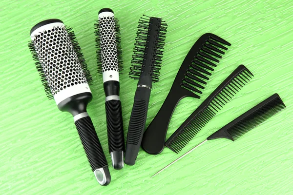 Black combs on color background — Stock Photo, Image