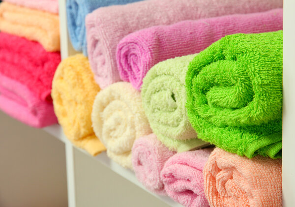 colorful towels on shelves in bathroom