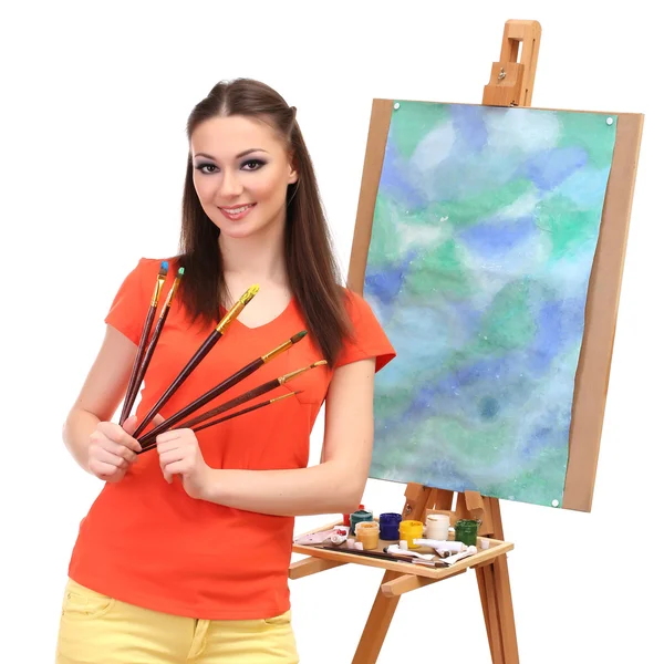 Beautiful young woman painter with brushes, isolated on white — Stock Photo, Image