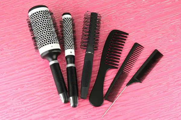 Black combs on color background — Stock Photo, Image