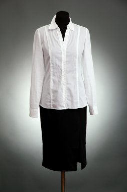 Beyaz bluz ve manken üzerinde gri arka plan üzerinde siyah etek