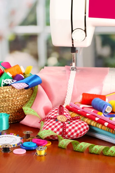 Sewing machine and fabric on bright background — Stock Photo, Image